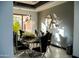 Stylish dining room with a decorative mirror, sleek furniture, and a window with abundant light at 22339 N 77Th Way, Scottsdale, AZ 85255
