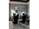 An elegant dining area featuring a mirrored wall, modern lighting, and a garden view at 22339 N 77Th Way, Scottsdale, AZ 85255