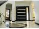 Bright foyer featuring a modern door, tile floors, and views to the second level at 22339 N 77Th Way, Scottsdale, AZ 85255