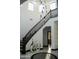 Bright foyer features white walls, black banister staircase, and a modern pendant light fixture at 22339 N 77Th Way, Scottsdale, AZ 85255