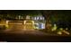 Night view of home featuring a three car garage, tile roof, and desert landscaping at 22339 N 77Th Way, Scottsdale, AZ 85255
