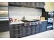 Modern kitchen features gray wood cabinets, stainless steel appliances, and marble backsplash at 22339 N 77Th Way, Scottsdale, AZ 85255