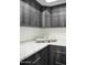 Functional laundry room with dark cabinets, a white countertop, and modern appliances at 22339 N 77Th Way, Scottsdale, AZ 85255