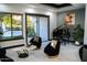 Modern living room with black accent chairs, grand piano and sliding doors at 22339 N 77Th Way, Scottsdale, AZ 85255