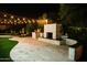 The outdoor kitchen is complete with built-in BBQ and fireplace, offering an elegant space for outdoor cooking and entertaining at 22339 N 77Th Way, Scottsdale, AZ 85255