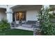Covered patio with modern outdoor furniture, gas fireplace, and sliding glass doors to the home at 22339 N 77Th Way, Scottsdale, AZ 85255
