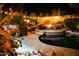 A serene pool features a firepit lounge area, surrounded by lush greenery and soft lighting for ultimate relaxation at 22339 N 77Th Way, Scottsdale, AZ 85255