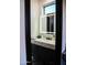 Modern powder room with a sleek vanity, illuminated mirror, and stylish fixtures at 22339 N 77Th Way, Scottsdale, AZ 85255