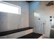 Spacious shower with marble tile, bench seating, and modern shower fixtures for a luxurious experience at 22339 N 77Th Way, Scottsdale, AZ 85255