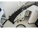 Modern staircase with black handrails, decorative lighting, and white vases at 22339 N 77Th Way, Scottsdale, AZ 85255