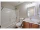 Bathroom featuring a shower-tub combo, wood vanity, a framed mirror and modern sink at 22583 W Lasso Ln, Buckeye, AZ 85326