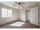 This cozy bedroom features neutral walls, carpet flooring, a ceiling fan and closet at 22583 W Lasso Ln, Buckeye, AZ 85326