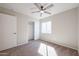 A well-lit bedroom featuring carpet floors, neutral walls, a ceiling fan and closet at 22583 W Lasso Ln, Buckeye, AZ 85326