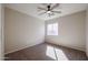 A minimalist bedroom with neutral walls, carpet floors and a window for natural lighting at 22583 W Lasso Ln, Buckeye, AZ 85326