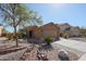 Charming single-Gathering home featuring desert landscaping, a two-car garage, and neutral stucco exterior at 22583 W Lasso Ln, Buckeye, AZ 85326
