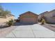 Traditional single-story home featuring desert landscaping, a neutral stucco exterior, and a two-car garage at 22583 W Lasso Ln, Buckeye, AZ 85326