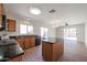 Open kitchen featuring a center island, black countertops, wood cabinets, and stainless steel appliances at 22583 W Lasso Ln, Buckeye, AZ 85326