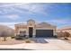 Charming single-story home featuring a two-car garage and well-kept landscaping on a sunny day at 25615 W Allen St, Buckeye, AZ 85326