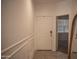 Bright hallway featuring stylish tile flooring, elegant trim, and a doorway to an adjacent room at 25615 W Allen St, Buckeye, AZ 85326