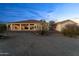 Vast backyard with native desert plants and a covered patio, perfect for outdoor activities and relaxation at 2855 N Silver Spur Dr, Wickenburg, AZ 85390