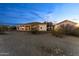 The backyard features a spacious covered patio and desert surroundings, perfect for enjoying the outdoors at 2855 N Silver Spur Dr, Wickenburg, AZ 85390