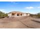 The backyard showcases a covered patio and desert landscaping, offering a serene retreat at 2855 N Silver Spur Dr, Wickenburg, AZ 85390
