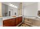 Bathroom featuring double sinks, vanity, and a luxurious soaking tub at 2855 N Silver Spur Dr, Wickenburg, AZ 85390