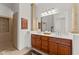 Bright bathroom with double vanity, a large mirror, and a walk-in shower at 2855 N Silver Spur Dr, Wickenburg, AZ 85390