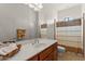 Bright bathroom featuring a neutral-toned shower curtain, a spacious vanity, and a large mirror at 2855 N Silver Spur Dr, Wickenburg, AZ 85390