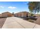 Sprawling home featuring desert landscaping, a long driveway, and an attached three-car garage at 2855 N Silver Spur Dr, Wickenburg, AZ 85390