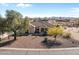 Exterior view of the house, featuring desert landscaping, tile roof and mountain views at 2855 N Silver Spur Dr, Wickenburg, AZ 85390