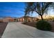Inviting desert home featuring a long private drive, 3 car garage, and separate auxiliary garage/workshop at 2855 N Silver Spur Dr, Wickenburg, AZ 85390