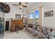 Charming living room with natural light, a vintage desk, and a cozy patterned sofa at 2855 N Silver Spur Dr, Wickenburg, AZ 85390
