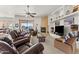 Bright living room with leather furniture, fireplace, and built-in shelving at 2855 N Silver Spur Dr, Wickenburg, AZ 85390