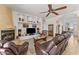Comfortable living room with fireplace, built-in shelves, and elegant tile flooring at 2855 N Silver Spur Dr, Wickenburg, AZ 85390