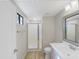 Modern bathroom with a glass-enclosed shower, a white vanity, and tile floors at 295 N Rural Rd # 128, Chandler, AZ 85226