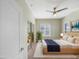 Cozy bedroom showcasing soft natural light, a ceiling fan, and mirrored closet at 295 N Rural Rd # 128, Chandler, AZ 85226