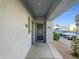 Inviting doorway with secure metal door, stone landscaping, and clearly marked unit numbers at 295 N Rural Rd # 128, Chandler, AZ 85226