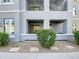 Charming condo features a balcony and a well-maintained landscape with decorative stones and green bushes at 295 N Rural Rd # 128, Chandler, AZ 85226