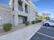 Modern condo building featuring well-maintained landscaping and reserved parking spaces at 295 N Rural Rd # 128, Chandler, AZ 85226