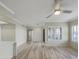 Bright living room with wood floors, crown molding, a ceiling fan and a door to the patio at 295 N Rural Rd # 128, Chandler, AZ 85226