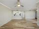 Bright living room featuring hardwood floors, a ceiling fan, and an open floor plan at 295 N Rural Rd # 128, Chandler, AZ 85226