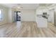 Bright open-plan living room featuring new wood floors and an adjoining kitchen at 295 N Rural Rd # 128, Chandler, AZ 85226