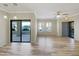 Spacious living room with wood flooring, ceiling fan, and sliding glass doors leading to a balcony at 295 N Rural Rd # 128, Chandler, AZ 85226