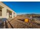 Spacious backyard featuring a covered patio and dirt area with a fence overlooking the natural desert landscape at 4289 W Caribou Ln, Queen Creek, AZ 85142