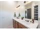 Elegant bathroom featuring a double sink vanity with quartz countertop, modern fixtures, and decorative mirror at 4289 W Caribou Ln, Queen Creek, AZ 85142