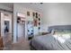 Stylish bedroom featuring a cozy gray bed, unique vinyl record decor, and a closet for ample storage at 4289 W Caribou Ln, Queen Creek, AZ 85142