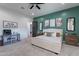 Bedroom featuring a large white bed, dark wood accents, and a cozy work space at 4289 W Caribou Ln, Queen Creek, AZ 85142