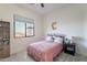 Charming bedroom featuring a comfortable bed, a large window with outdoor views, and simple yet stylish decor at 4289 W Caribou Ln, Queen Creek, AZ 85142
