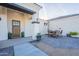Welcoming front entrance of a home featuring a wood door, neutral exterior, and a patio with comfortable outdoor seating at 4289 W Caribou Ln, Queen Creek, AZ 85142